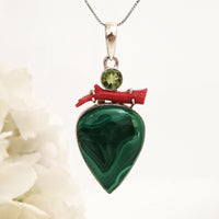Pine green pendant with malachite, peridot & Coral in high quality silver ready available at Nafisa Designs, Manchester UK. Free Global Shipping!
For Inquiries Call or WhatsApp: +447878581702 OR +96567725075