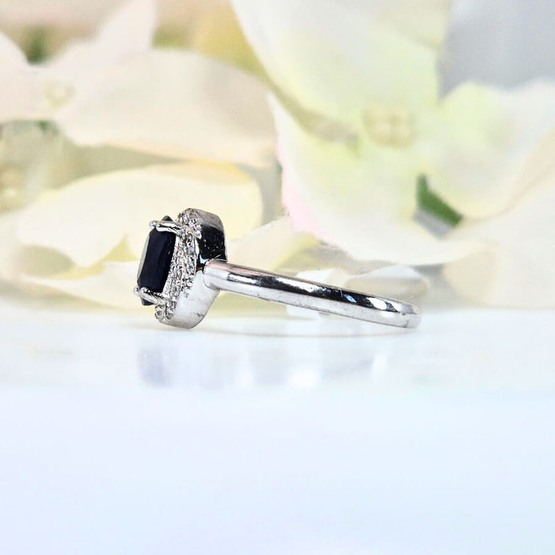 featuring a deep blue gemstone. High-quality