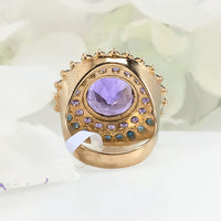 showcasing the vibrant colors of the violet amethyst center and the surrounding floral-like pattern of sapphires and amethysts.