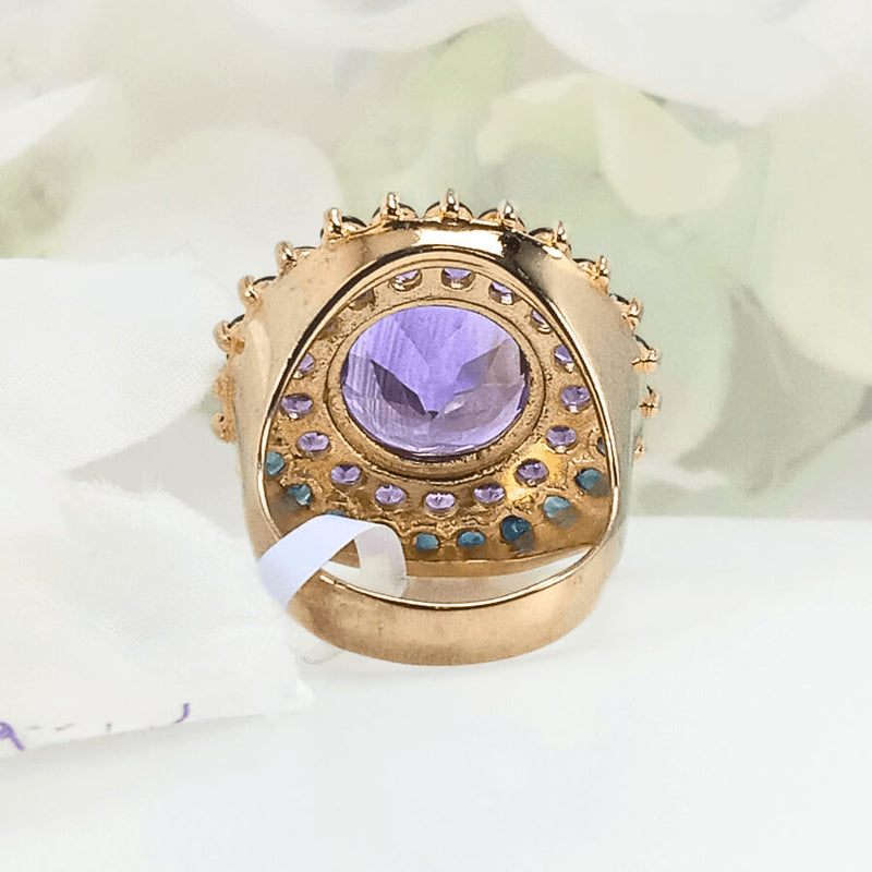 showcasing the vibrant colors of the violet amethyst center and the surrounding floral-like pattern of sapphires and amethysts.