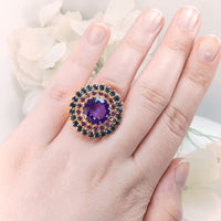 showing the detailed gold-plated silver band and the stunning arrangement of sapphire and amethyst gemstones.