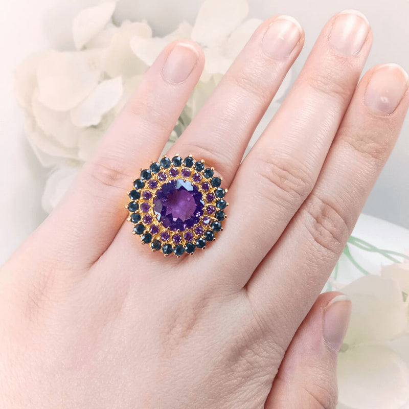 showing the detailed gold-plated silver band and the stunning arrangement of sapphire and amethyst gemstones.