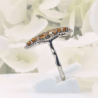 showcasing the radiant glow of the citrine gemstones set in a silver band