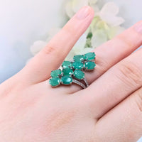 highlighting the depth of the green gemstones and the fun & interesting design