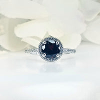 Front view of Women's Scarlet Passion Deep Red Garnet Ring in 925 Sterling Silver featuring a round crimson garnet gem in a sleek, intricate royal design