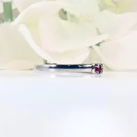 showcasing six pink rubies in a sleek and simple design