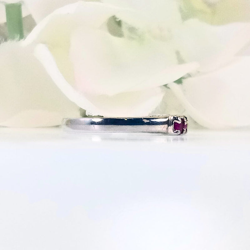 showcasing six pink rubies in a sleek and simple design