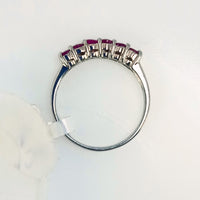 showcasing the smooth band and six pink rubies