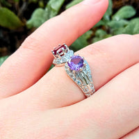 focusing on the sleek sterling silver band and the separation between the vibrant Amethyst on the left and Ruby on the right