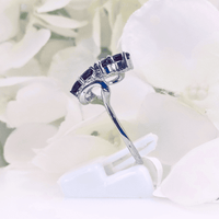 featuring four pear-shaped deep red garnet gemstones in a swirling pattern