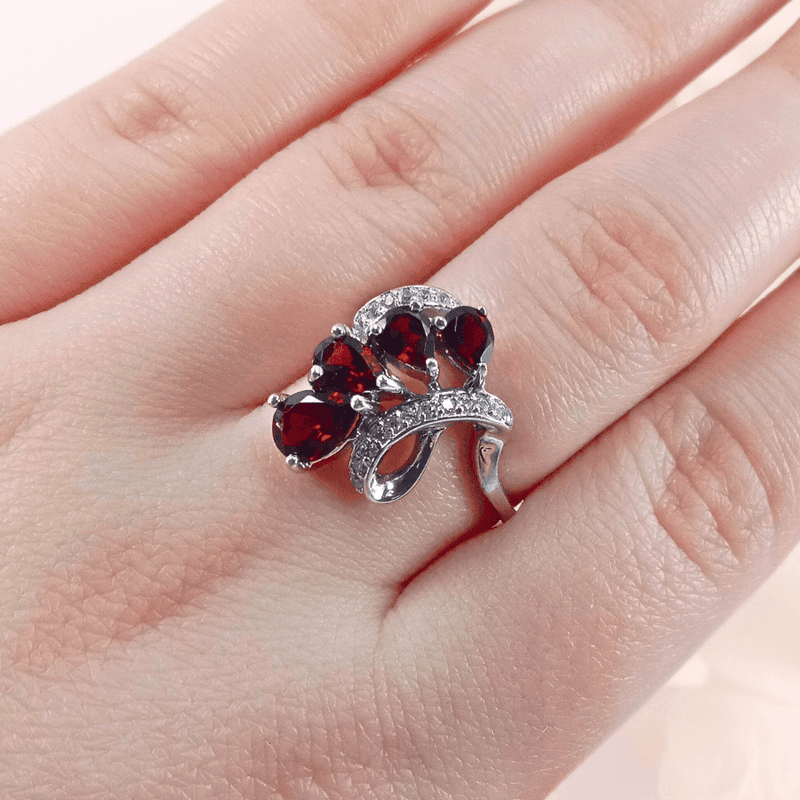 showcasing the intricate silver details and the elegant swirling pattern of garnet gemstones