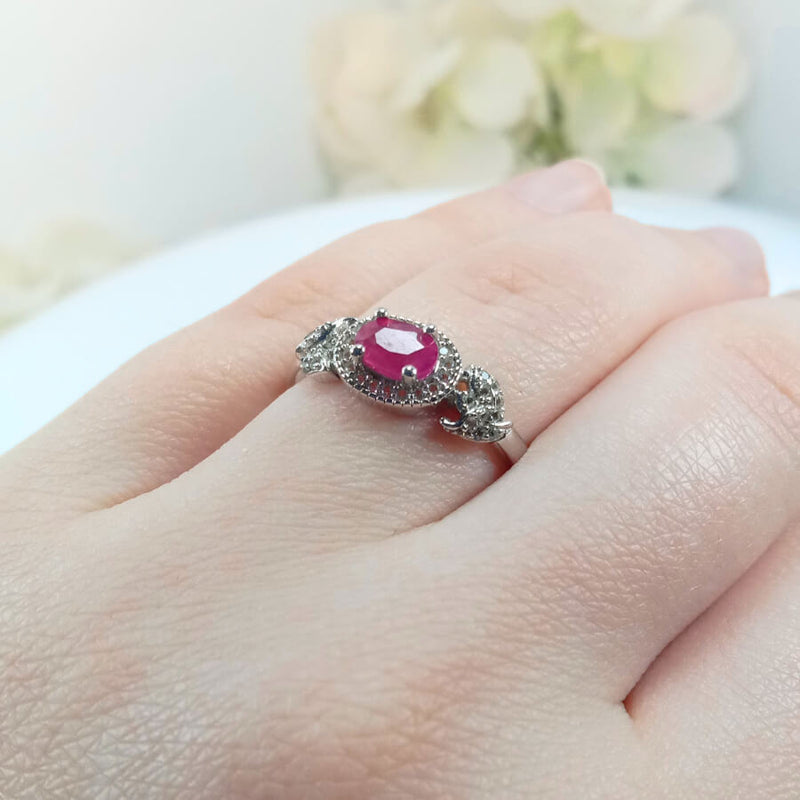 highlighting the detailed craftsmanship and delicate pink ruby centerpiece