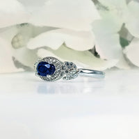 Front view of Women's Royal Deep Sea Blue Sapphire Ring in 925 Sterling Silver featuring a petite beautiful blue sapphire gem in a sleek