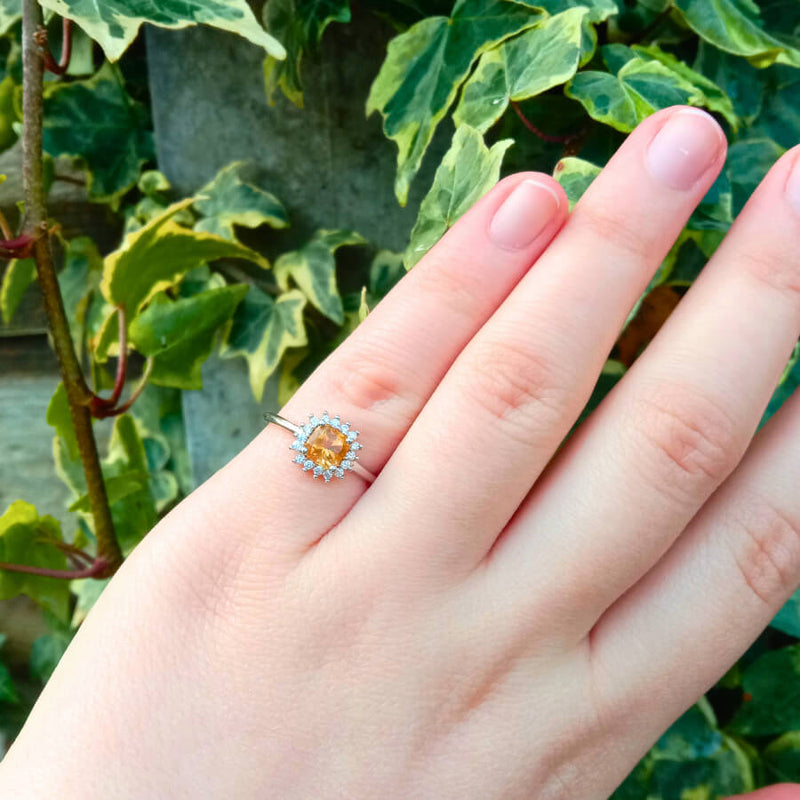 highlighting the smooth band and elegant setting of the radiant citrine gemstone