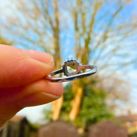 highlighting the depth and elegant design of the radiant gemstone set in the polished band