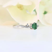 featuring a small verdant green gem