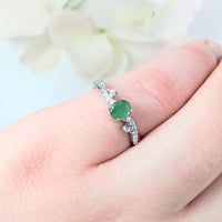highlighting the depth of the green gemstone and the elegant & delicate design
