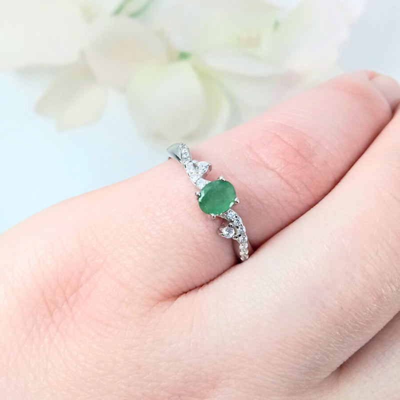highlighting the depth of the green gemstone and the elegant & delicate design