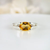 Elegant oval citrine silver ring featuring a vibrant yellow gemstone set in a polished 925 sterling silver band, showcasing a timeless design with a stunning gemstone centerpiece.
