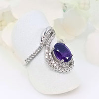 featuring a deep purple  gem