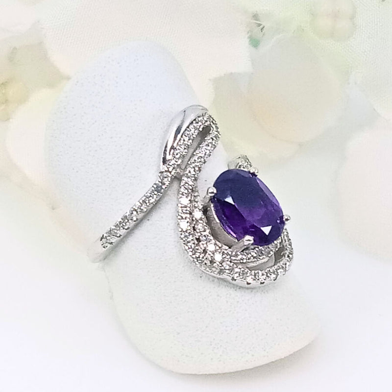 featuring a deep purple  gem