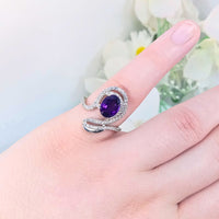 featuring a deep purple  gem