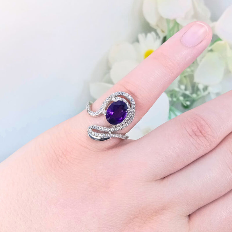 featuring a deep purple  gem